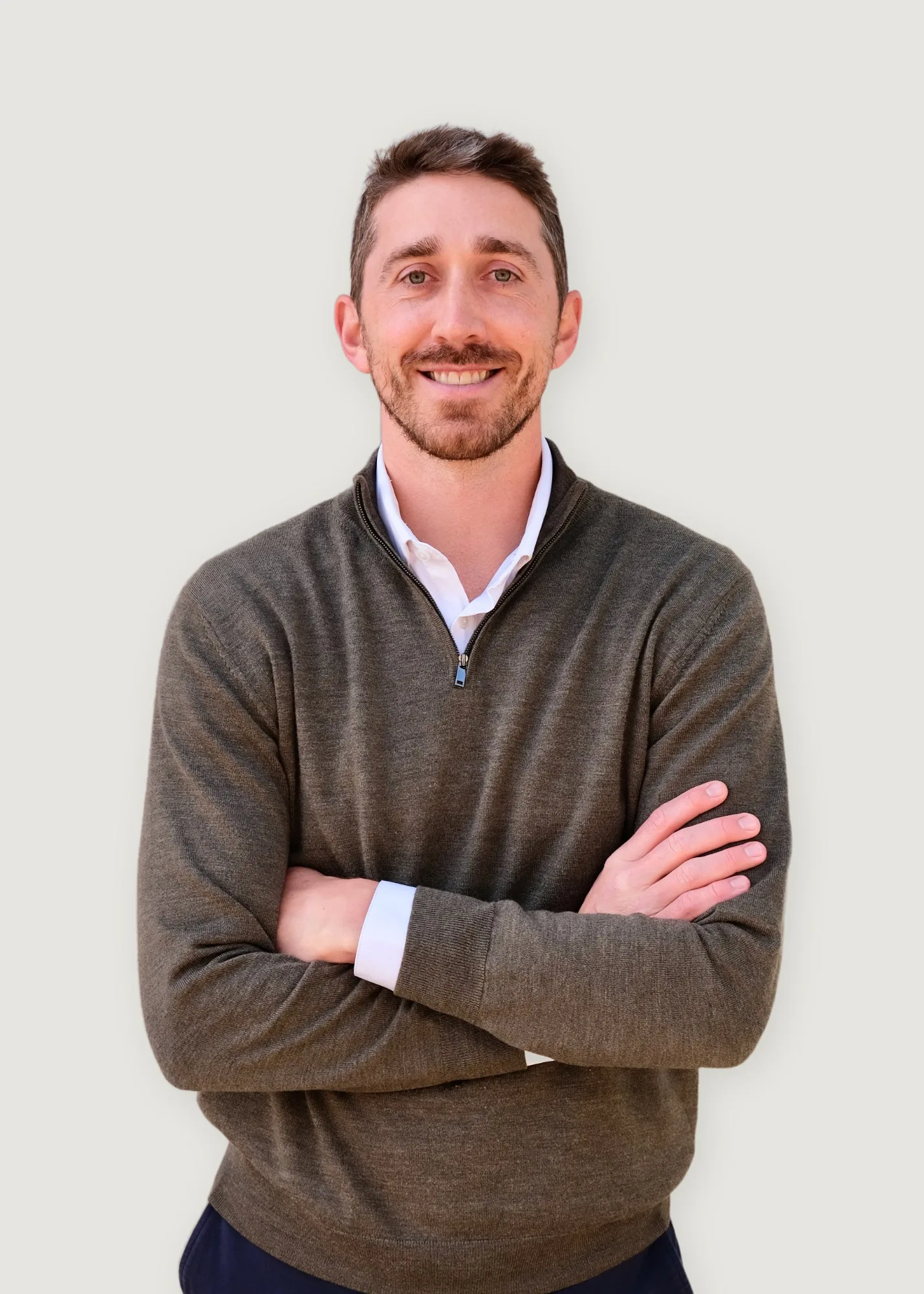 Luke MacDougall, founder of MacDougall Builders, arms crossed, in a studio portrait