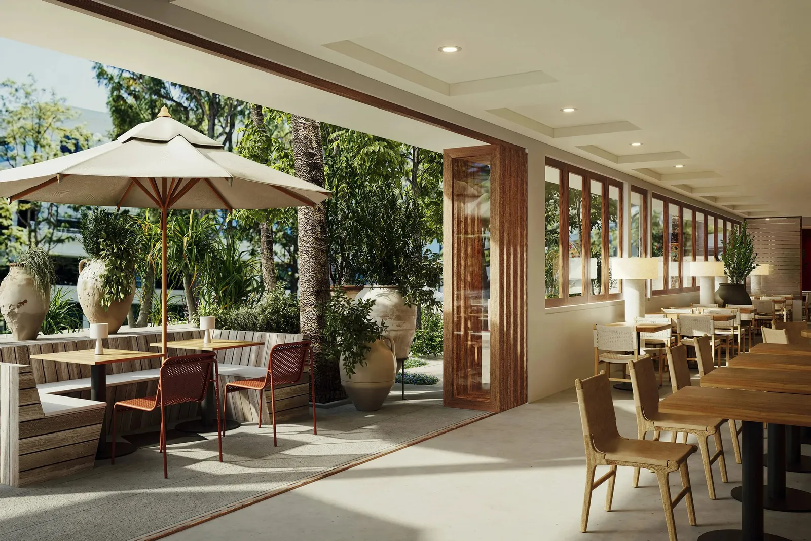 A dining room opening onto a terrace with umbrellas and palms
